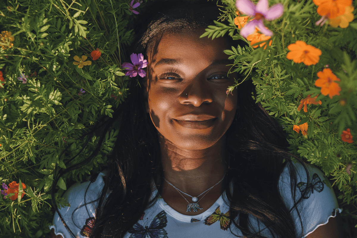 Black woman surrounded by flowers